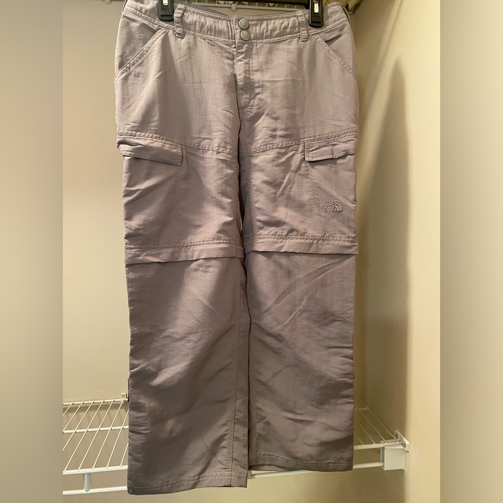 Ladies size 8 The North Face hiking pants with zip off, roll tab legs pockets.